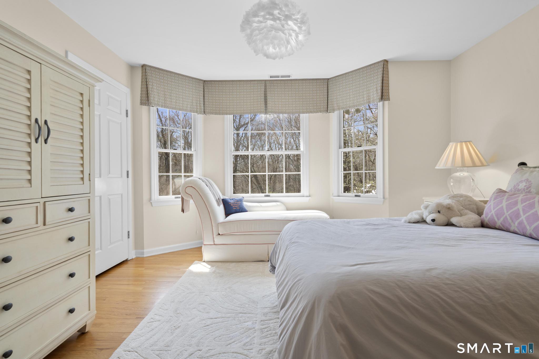 8 Maplewood Lane Wilton, CT 06897 - Photo 22 of 40 a bedroom with a large bed and a window