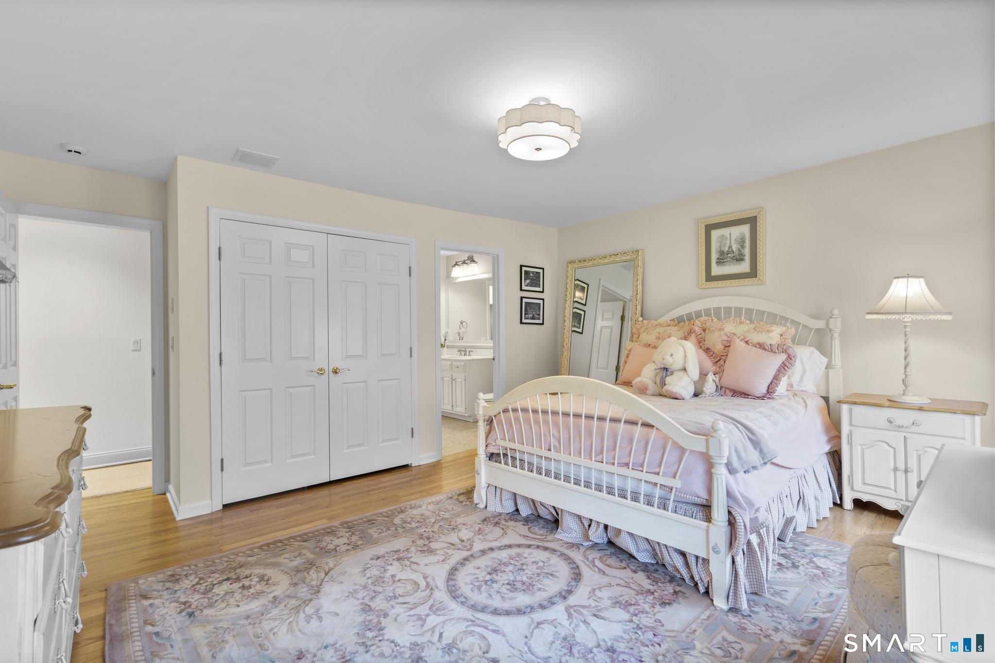 8 Maplewood Lane Wilton, CT 06897 - Photo 24 of 40 a bedroom with a bed and a lamp
