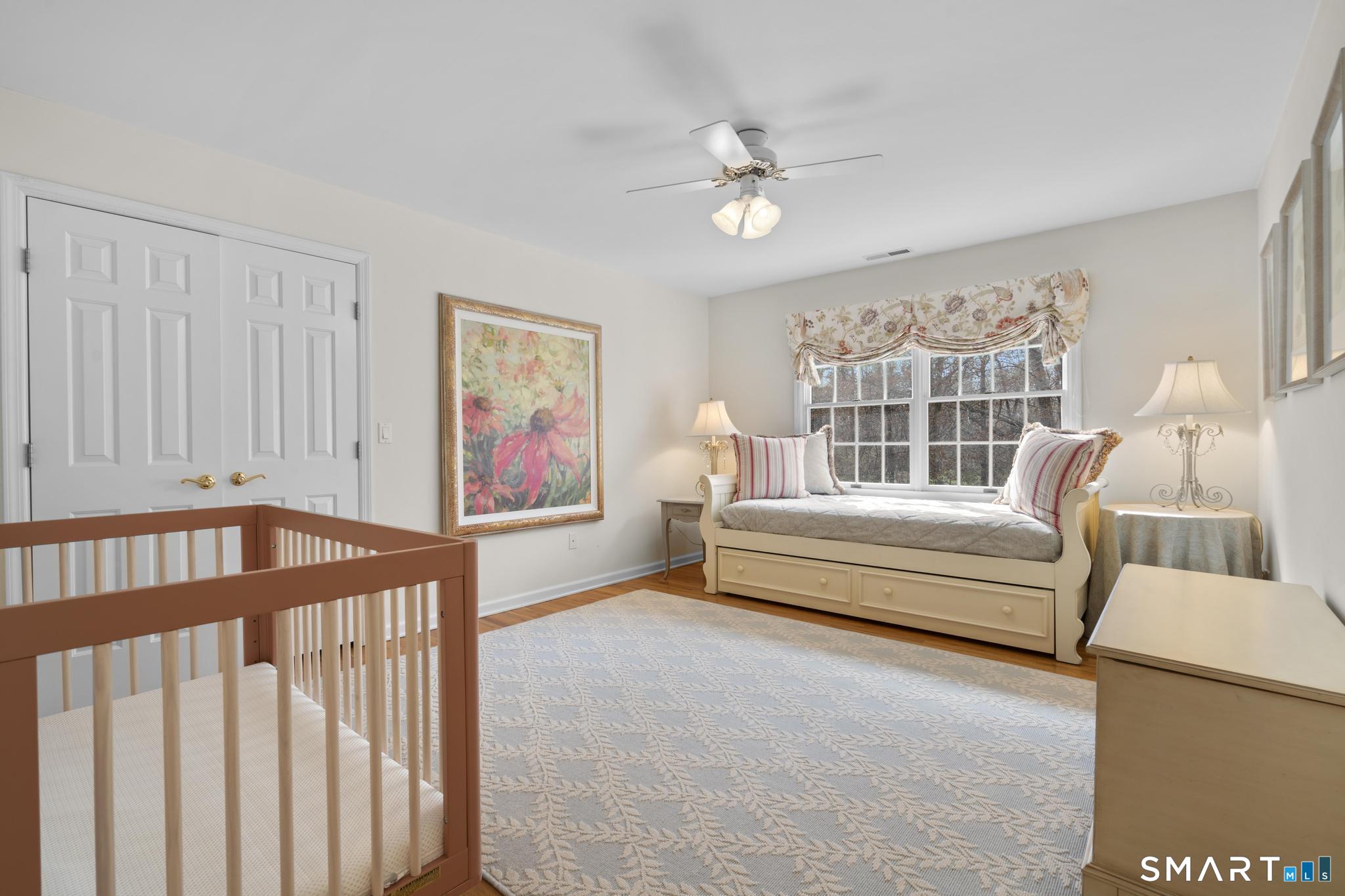 8 Maplewood Lane Wilton, CT 06897 - Photo 25 of 40 a bedroom with furniture and a window