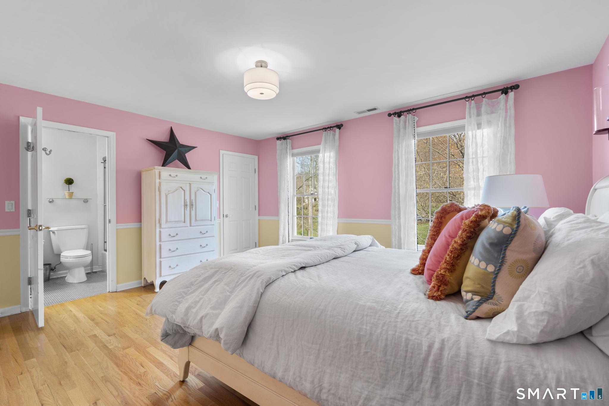 8 Maplewood Lane Wilton, CT 06897 - Photo 27 of 40 a bedroom with a bed and a large window