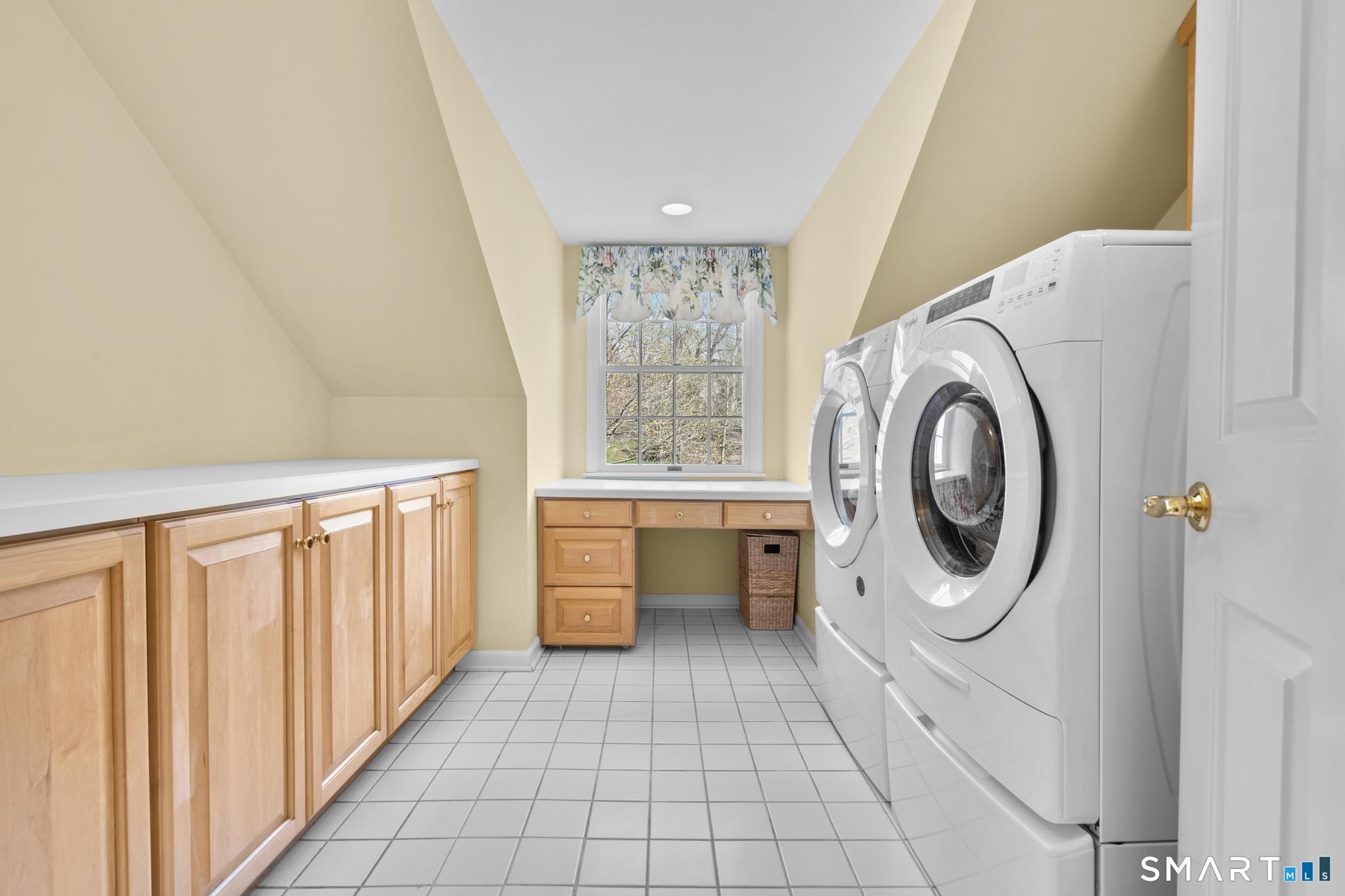 8 Maplewood Lane Wilton, CT 06897 - Photo 30 of 40 a bathroom with a sink a washer and dryer next to a window