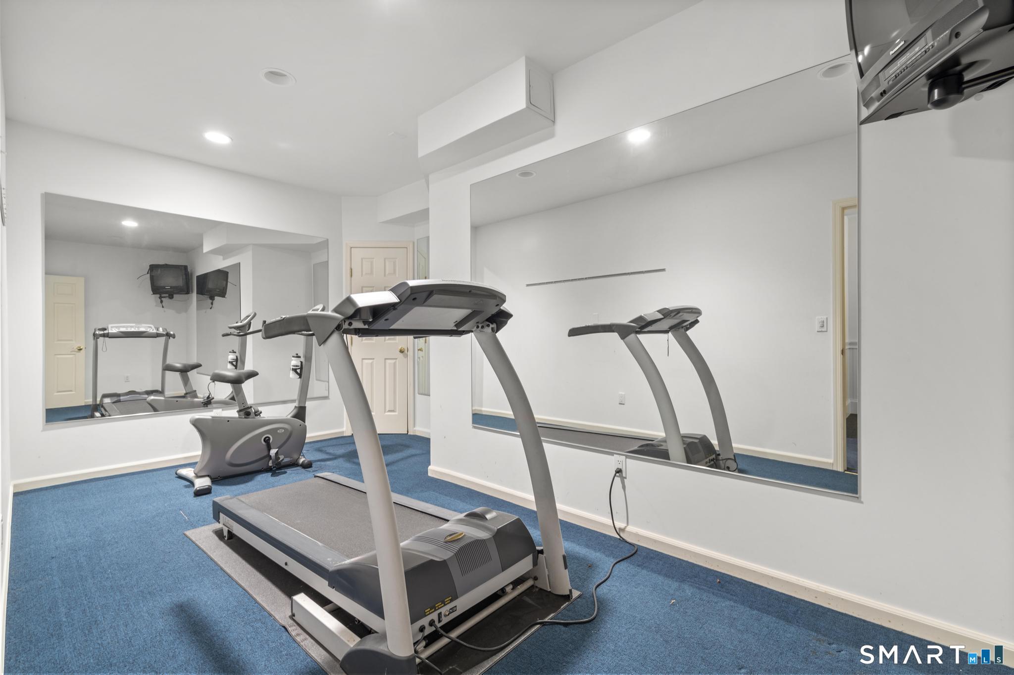 8 Maplewood Lane Wilton, CT 06897 - Photo 32 of 40 a room with gym equipment and wooden floor