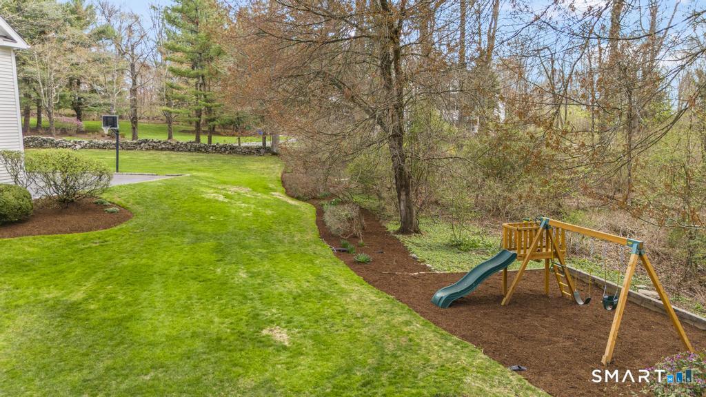 8 Maplewood Lane Wilton, CT 06897 - Photo 36 of 40 a view of a yard with furniture and a bench