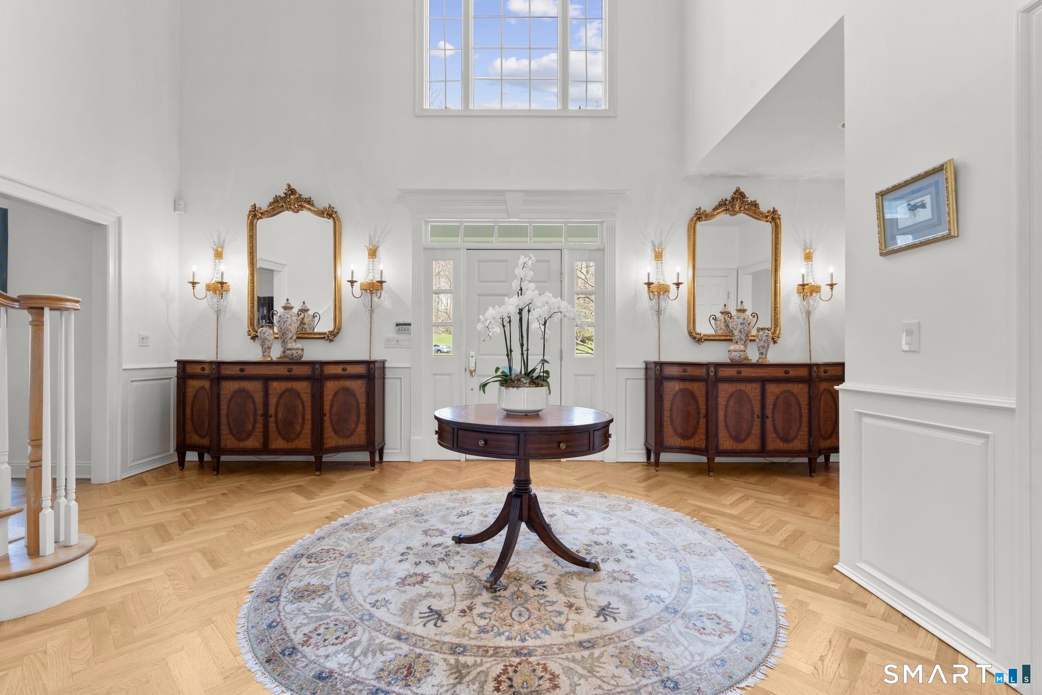 8 Maplewood Lane Wilton, CT 06897 - Photo 4 of 40 a living room with furniture a rug and a chandelier