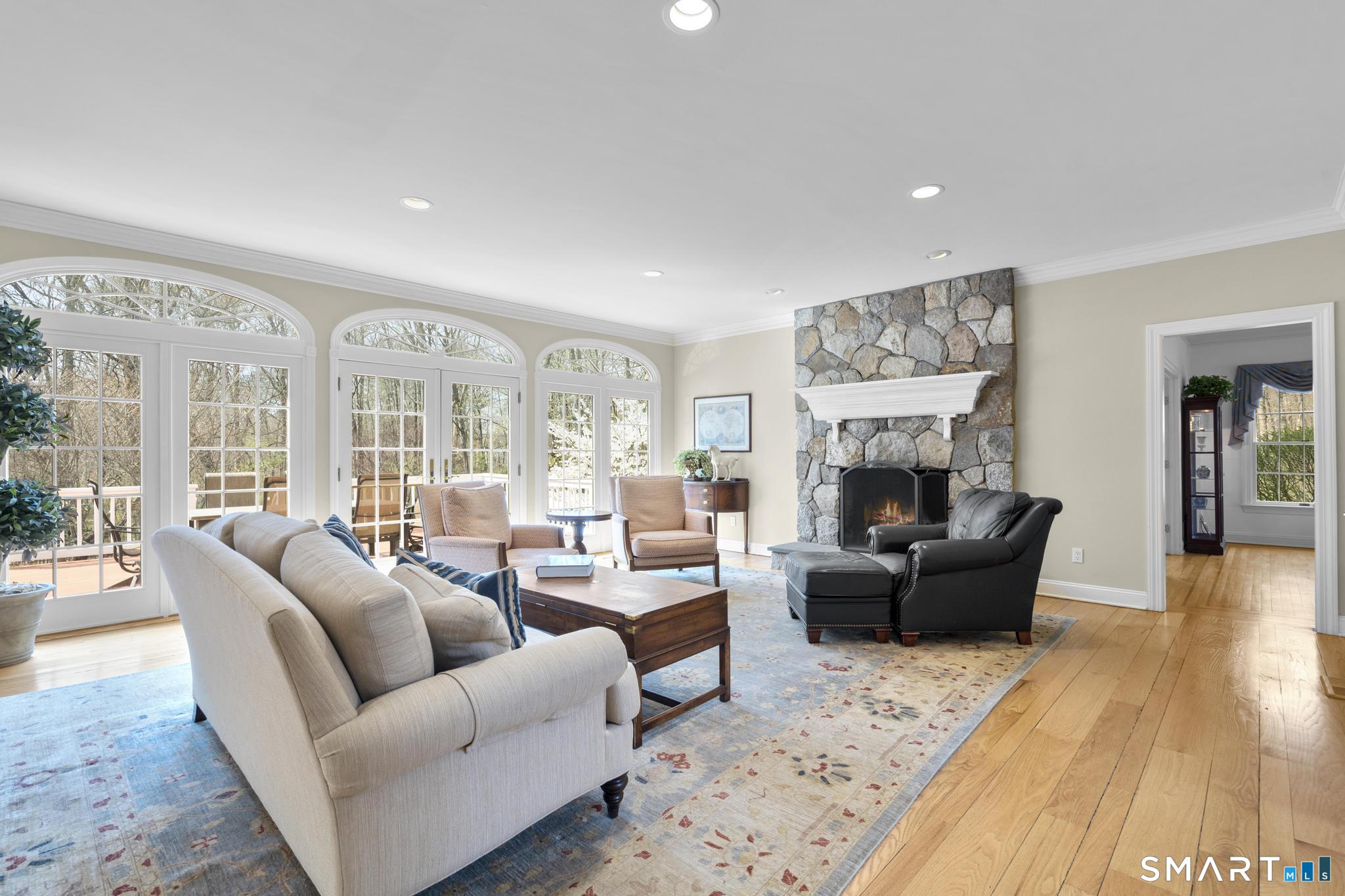 8 Maplewood Lane Wilton, CT 06897 - Photo 7 of 40 a living room with furniture fireplace and a table