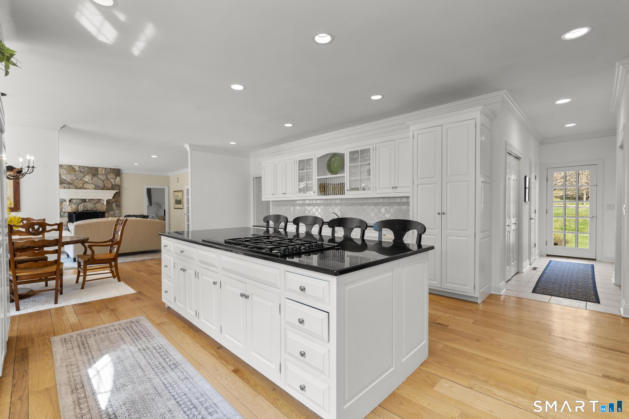 8 Maplewood Lane Wilton, CT 06897 - Photo 9 of 40 a kitchen with stainless steel appliances a stove a sink a counter top space and cabinets