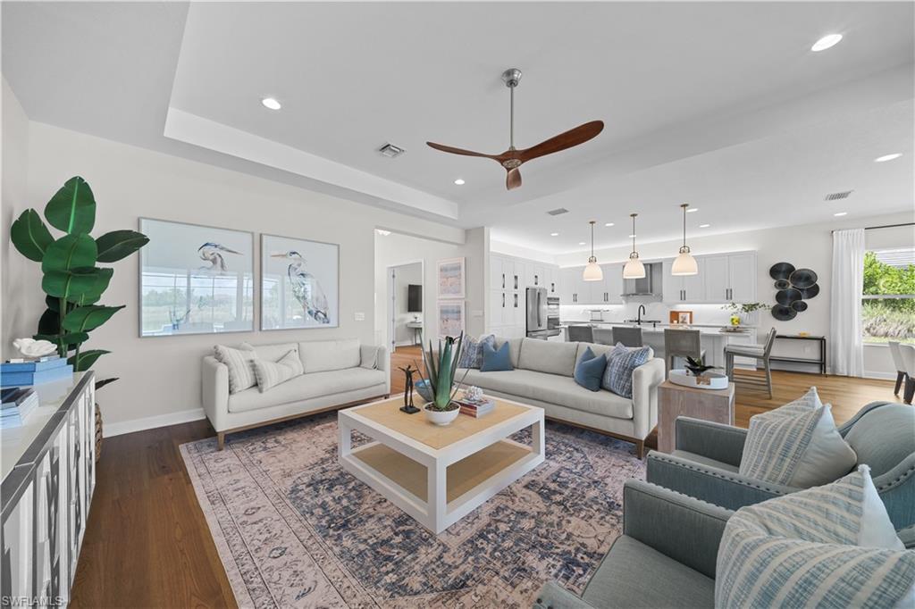 12092 Eucalyptus Way Naples, FL 34120 - Photo 11 of 50 a living room with furniture or couches and a coffee table