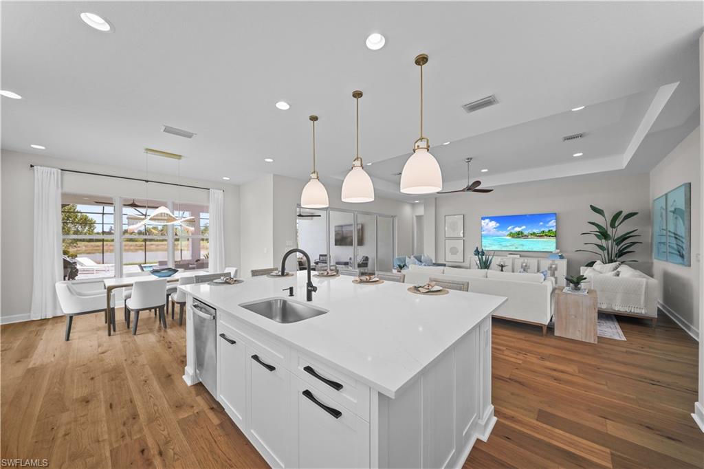 12092 Eucalyptus Way Naples, FL 34120 - Photo 13 of 50 a large kitchen with lots of counter space and stainless steel appliances