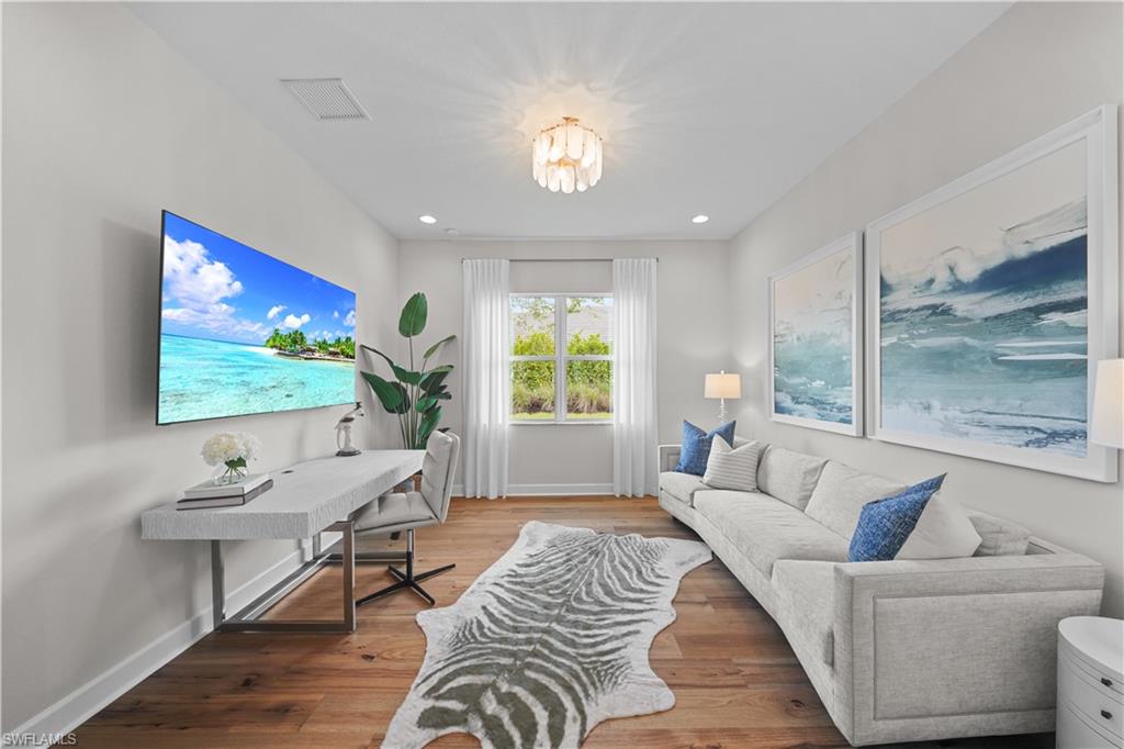 12092 Eucalyptus Way Naples, FL 34120 - Photo 15 of 50 a living room with furniture and a flat screen tv
