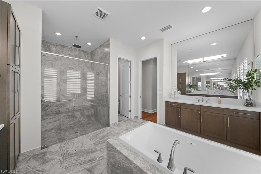 12092 Eucalyptus Way Naples, FL 34120 - Photo 18 of 50 a bathroom with a granite countertop sink mirror and shower