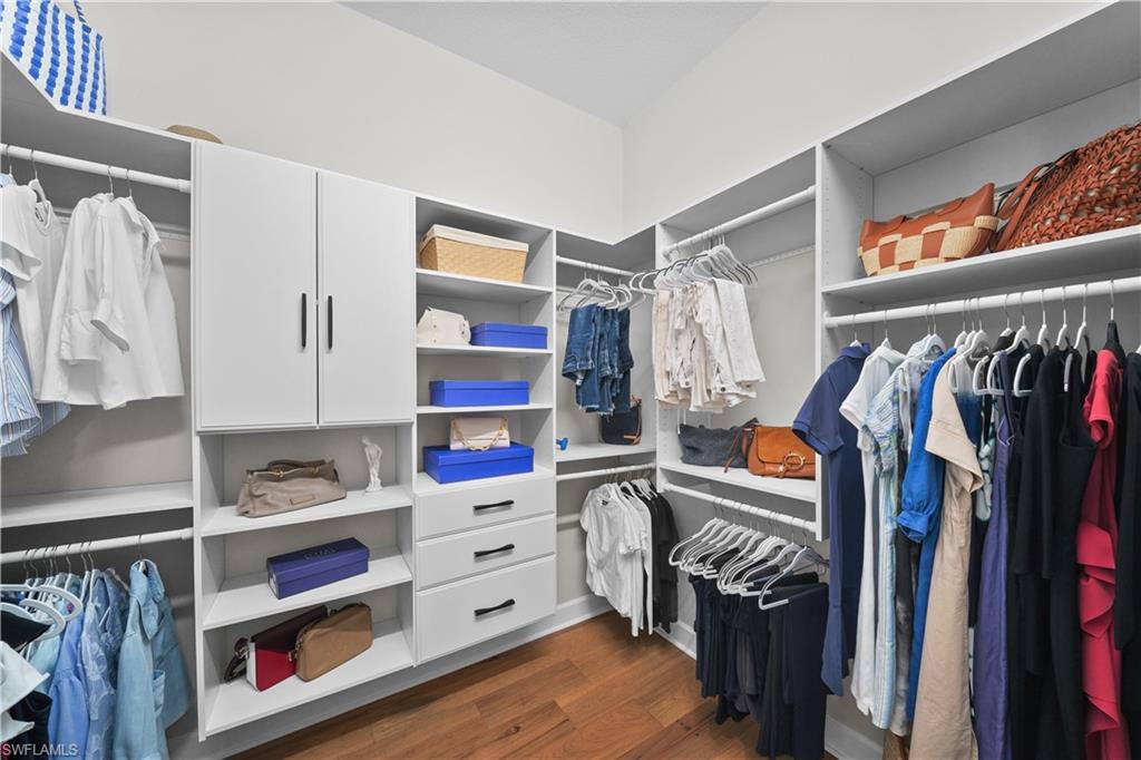 12092 Eucalyptus Way Naples, FL 34120 - Photo 19 of 50 a view of walk in closet with clothes and shoes