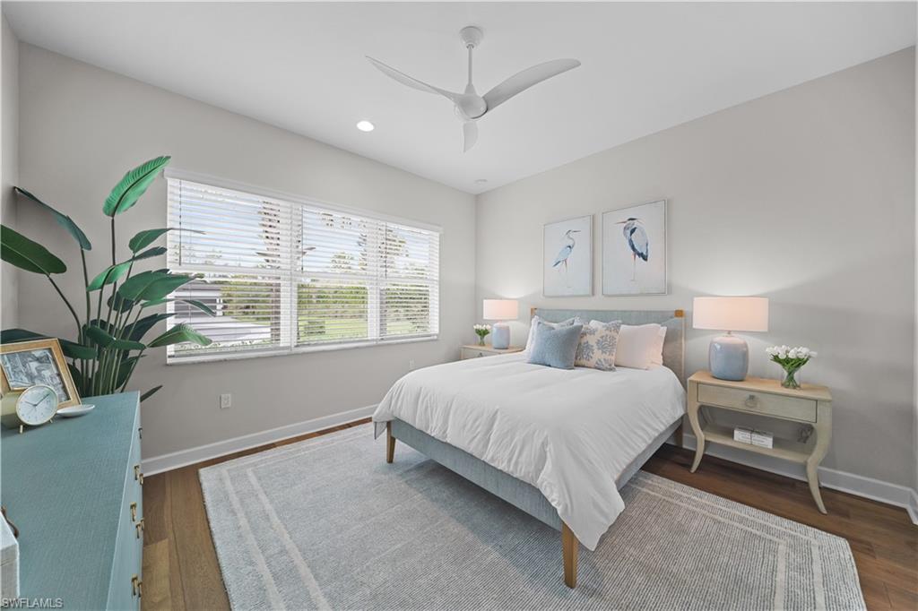 12092 Eucalyptus Way Naples, FL 34120 - Photo 20 of 50 a bedroom with a large bed and a large window
