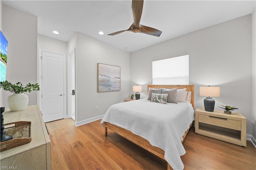 12092 Eucalyptus Way Naples, FL 34120 - Photo 22 of 50 a bedroom with a bed and a chandelier