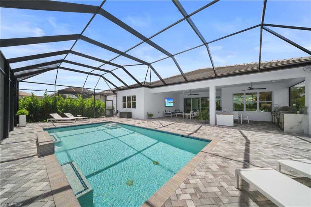 12092 Eucalyptus Way Naples, FL 34120 - Photo 30 of 50 a view of a backyard with sitting area