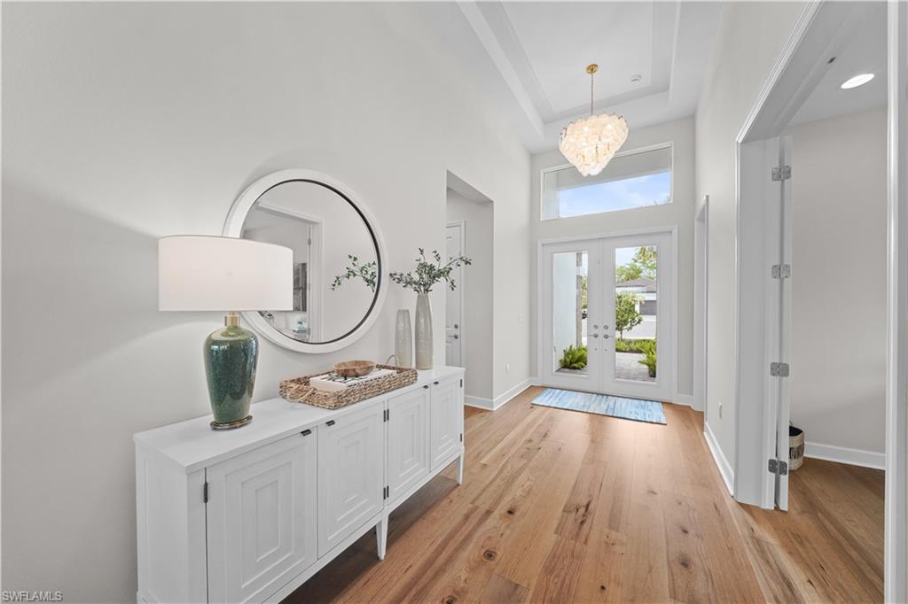 12092 Eucalyptus Way Naples, FL 34120 - Photo 3 of 50 a hallway with view of wooden floors