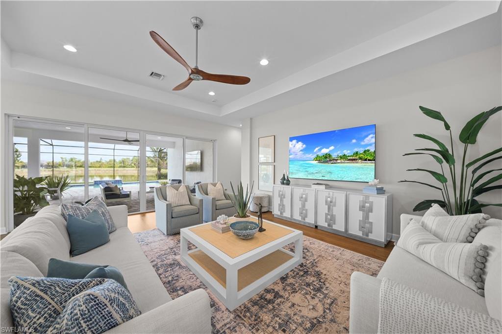 12092 Eucalyptus Way Naples, FL 34120 - Photo 5 of 50 a living room with furniture and a flat screen tv