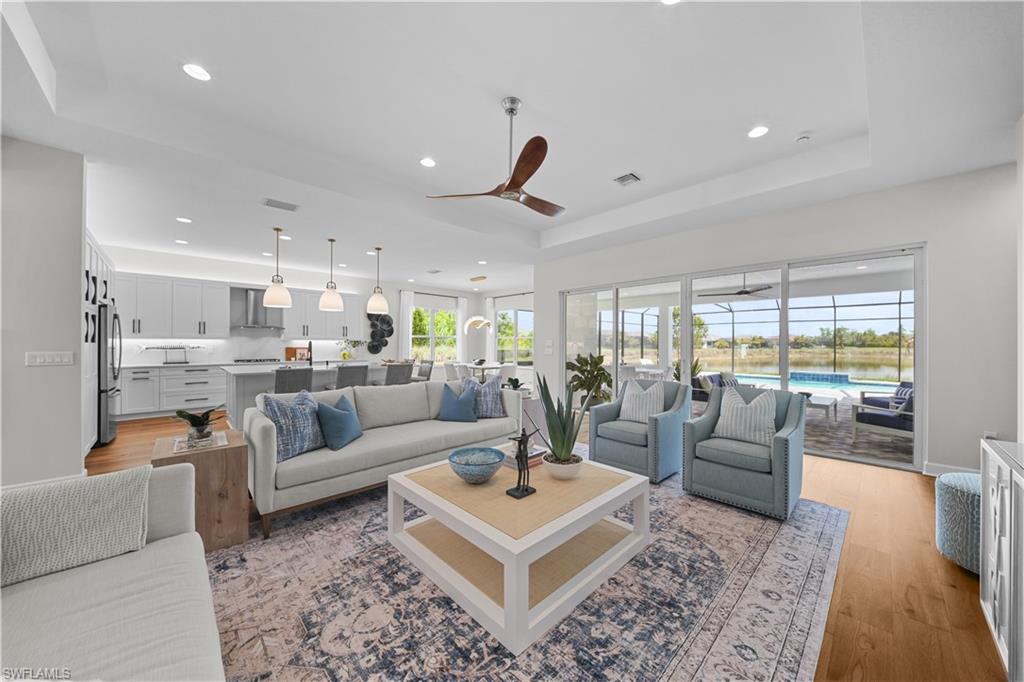12092 Eucalyptus Way Naples, FL 34120 - Photo 6 of 50 a living room with furniture and a large window