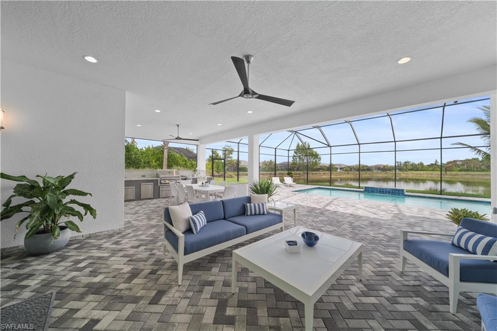 12092 Eucalyptus Way Naples, FL 34120 - Photo 7 of 50 a living room with furniture and a large window
