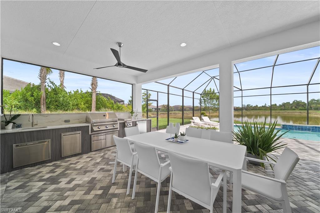12092 Eucalyptus Way Naples, FL 34120 - Photo 8 of 50 a kitchen with a table and chairs