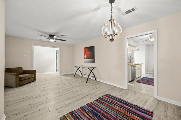 a view of a livingroom with furniture and a ceiling fan