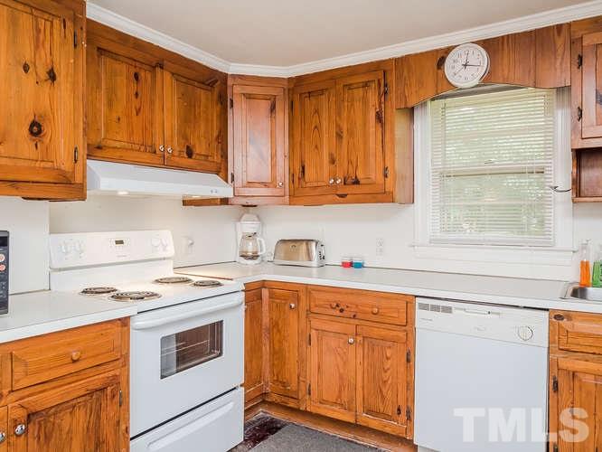 3607 North New Hope Road Raleigh, NC 27604 - Photo 3 of 24 a kitchen with stainless steel appliances granite countertop a sink and cabinets with wooden floor