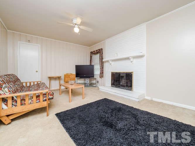 3607 North New Hope Road Raleigh, NC 27604 - Photo 8 of 24 a living room with furniture and a fireplace
