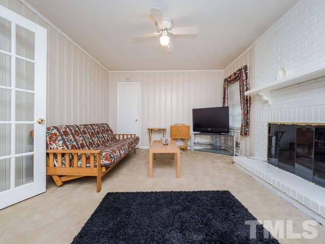 3607 North New Hope Road Raleigh, NC 27604 - Photo 9 of 24 a living room with furniture and a flat screen tv