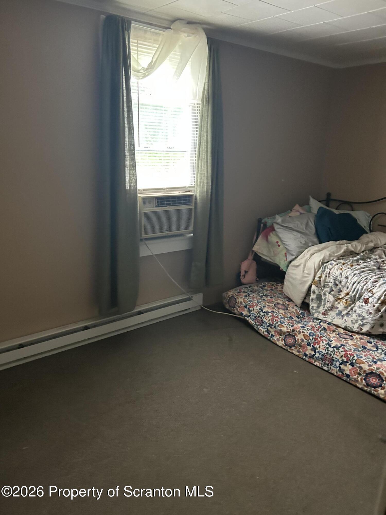 63 Shannon Street Simpson, PA 18407 - Photo 23 of 24 a bed sitting in a bedroom next to a window