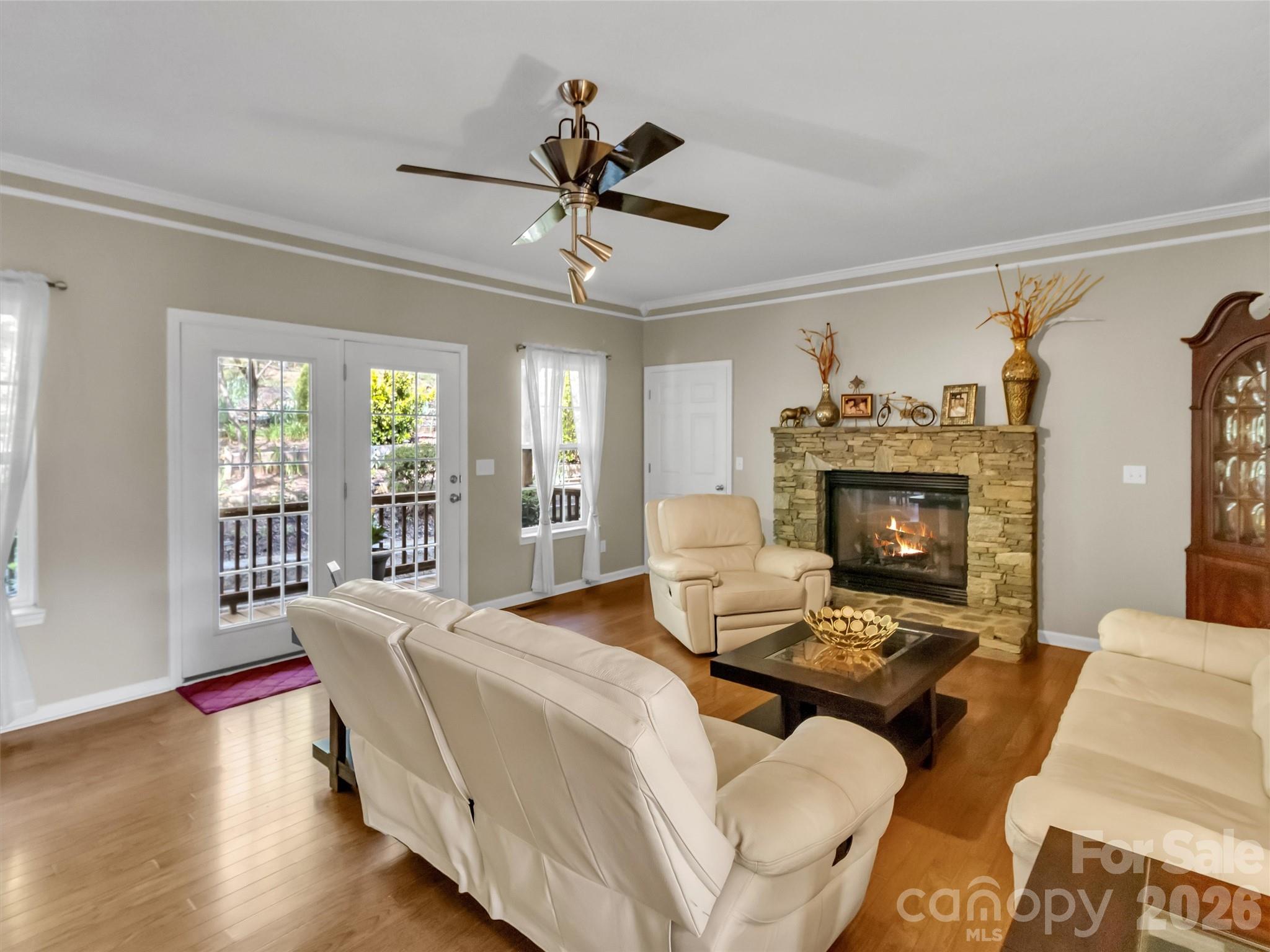 237 Midway Crossing Drive Clyde, NC 28721 - Photo 11 of 42 a living room with furniture a large window and a fireplace
