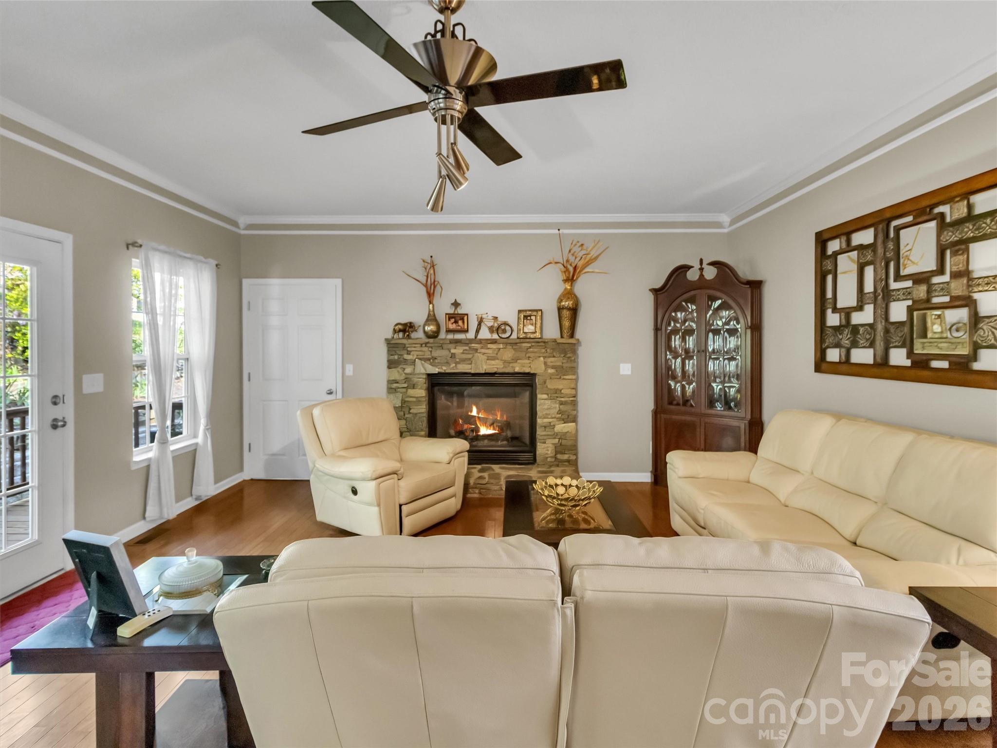 237 Midway Crossing Drive Clyde, NC 28721 - Photo 12 of 42 a living room with furniture a fireplace and a flat screen tv