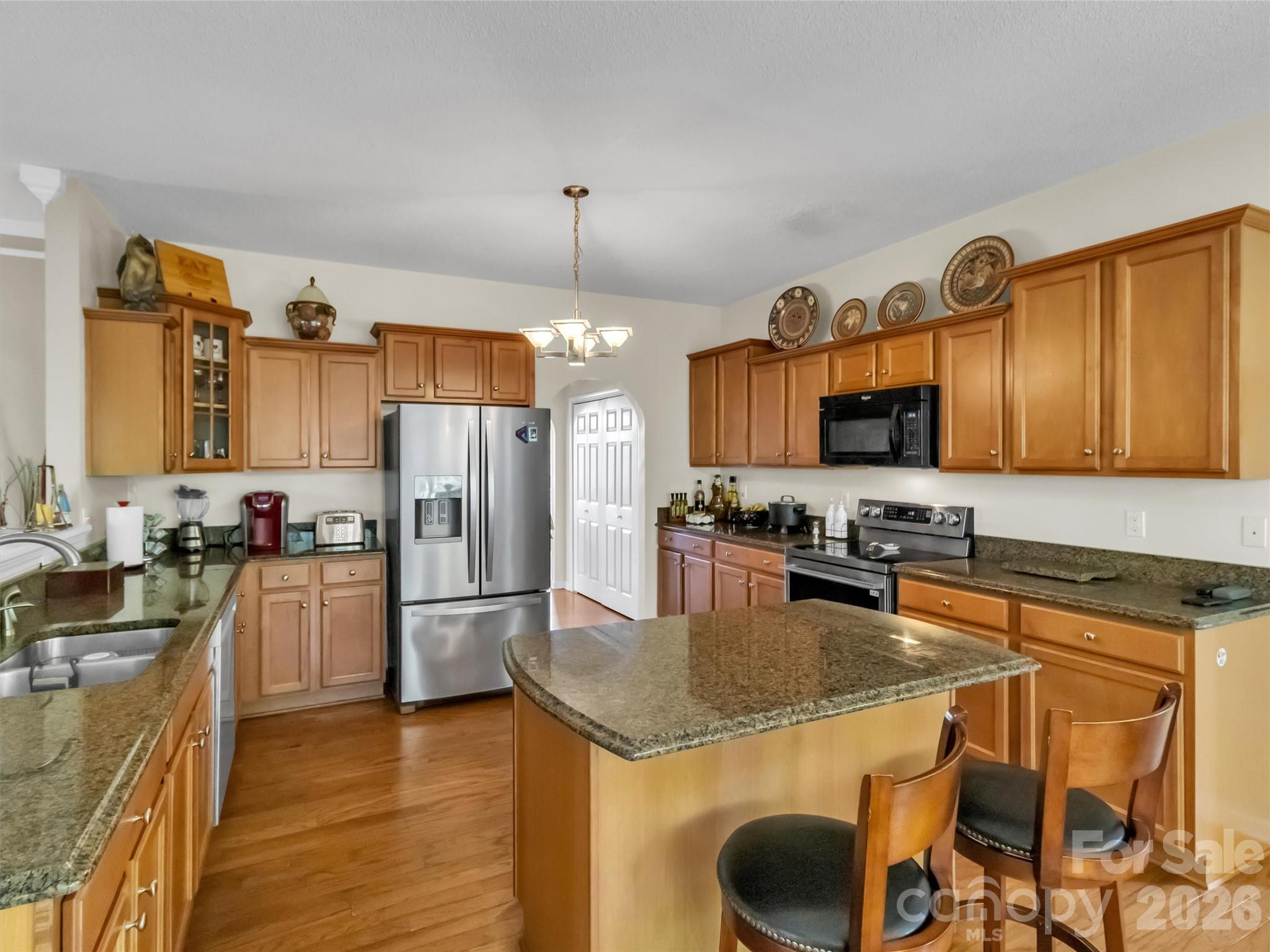 237 Midway Crossing Drive Clyde, NC 28721 - Photo 17 of 42 a kitchen with granite countertop a sink appliances and cabinets