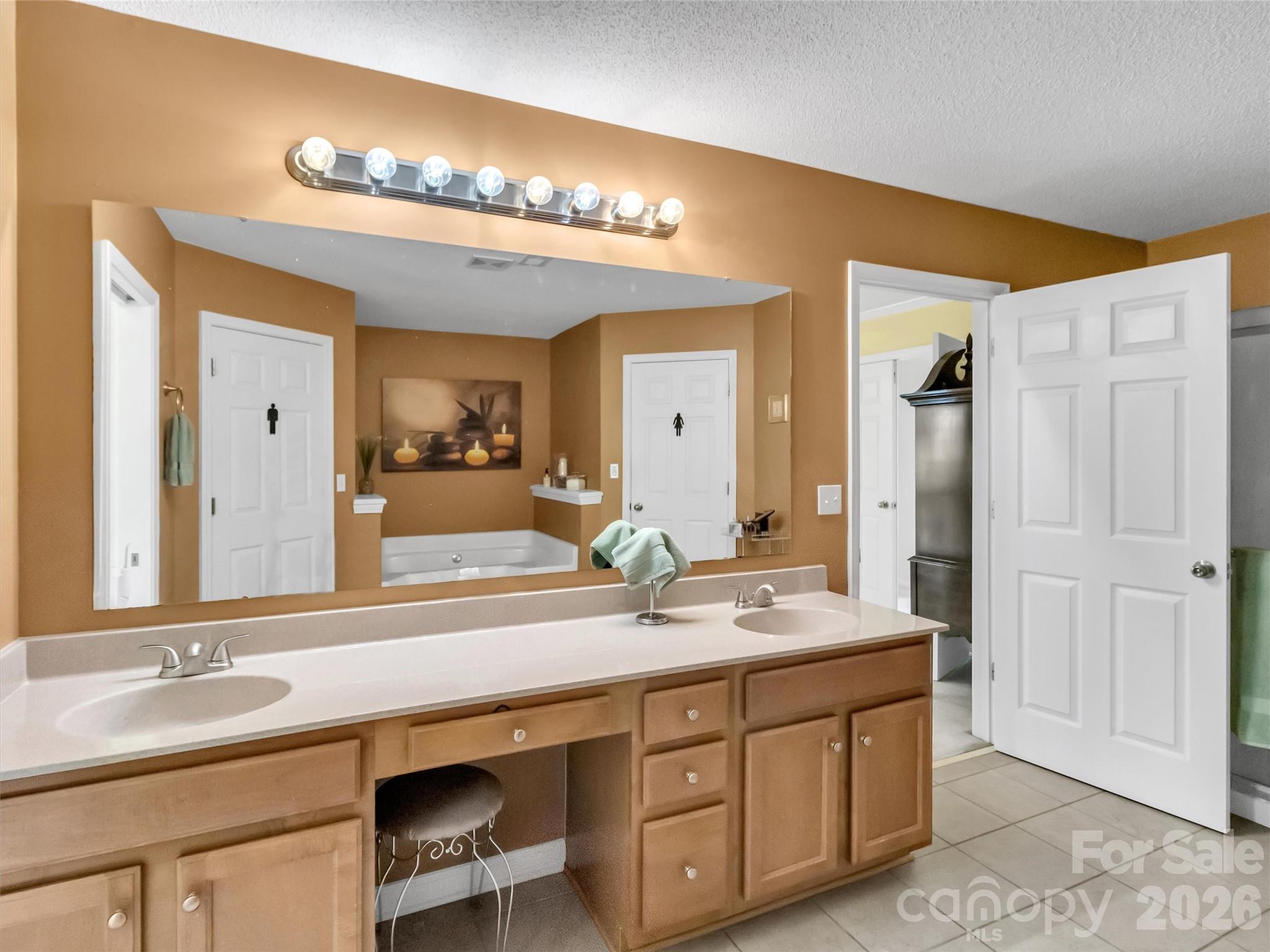 237 Midway Crossing Drive Clyde, NC 28721 - Photo 26 of 42 a bathroom with a double vanity sink and a mirror