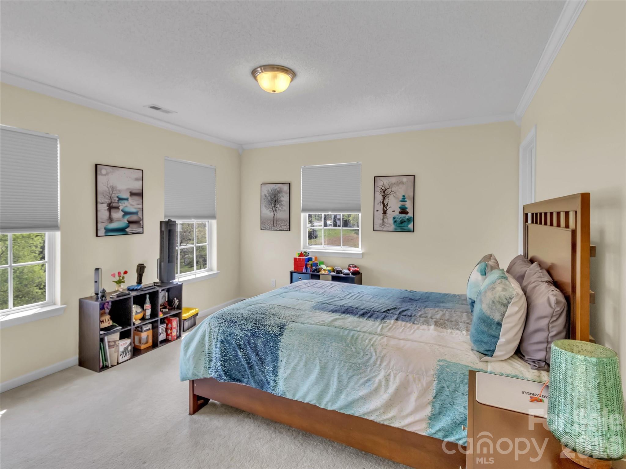 237 Midway Crossing Drive Clyde, NC 28721 - Photo 27 of 42 a bedroom with a bed and wooden floor