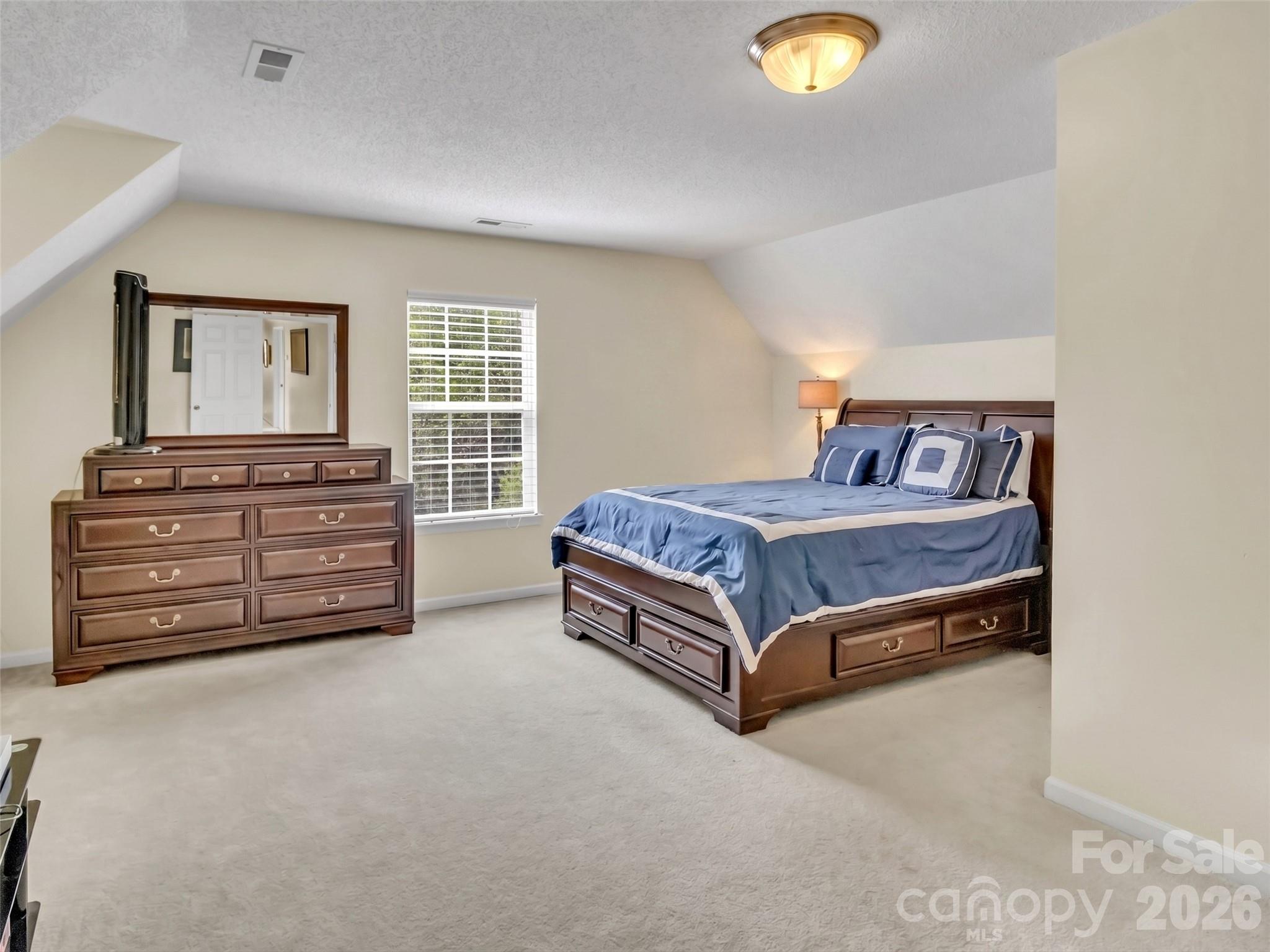237 Midway Crossing Drive Clyde, NC 28721 - Photo 28 of 42 a spacious bedroom with a bed and closet