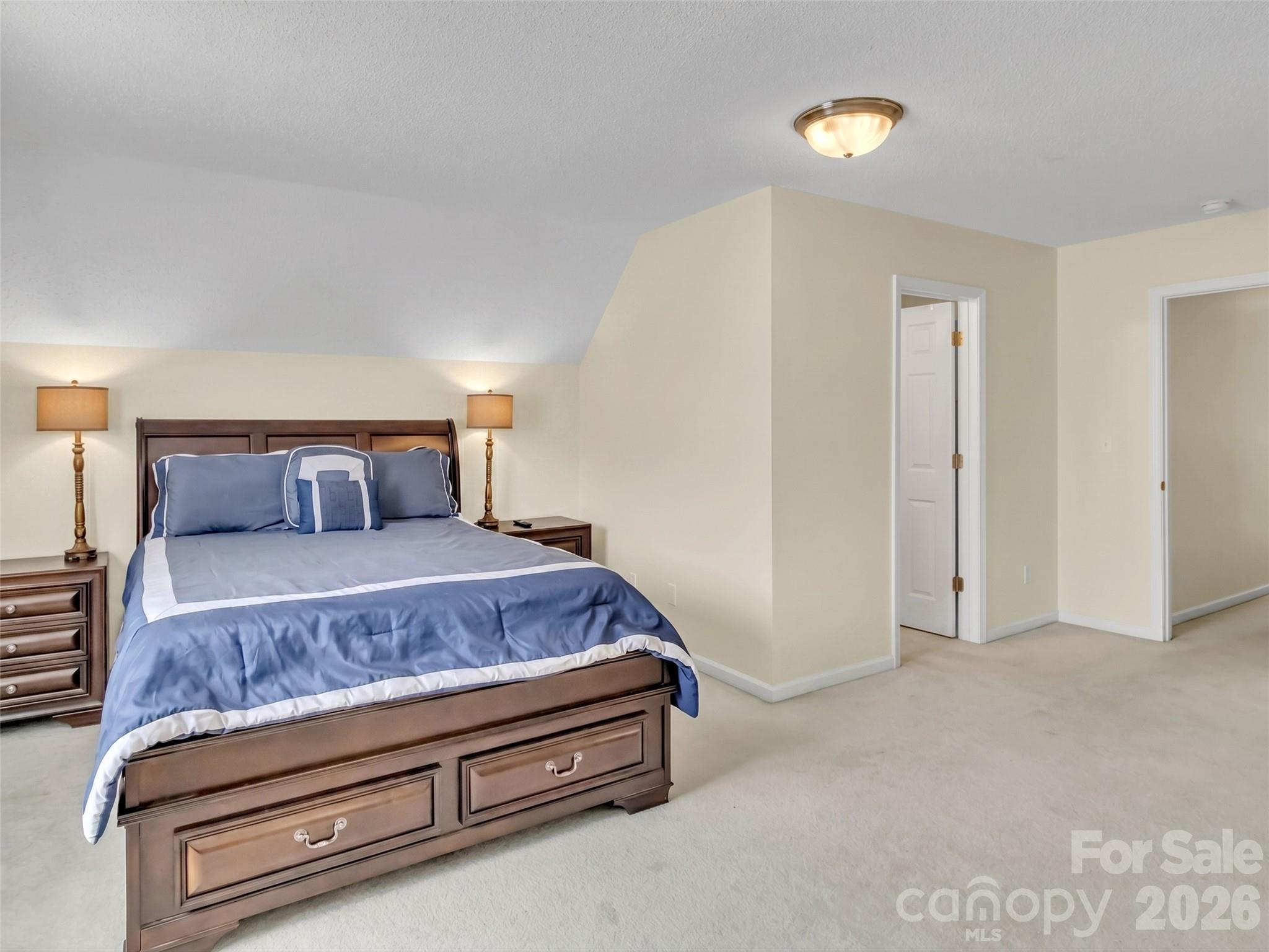 237 Midway Crossing Drive Clyde, NC 28721 - Photo 29 of 42 a bedroom with a bed and lamp