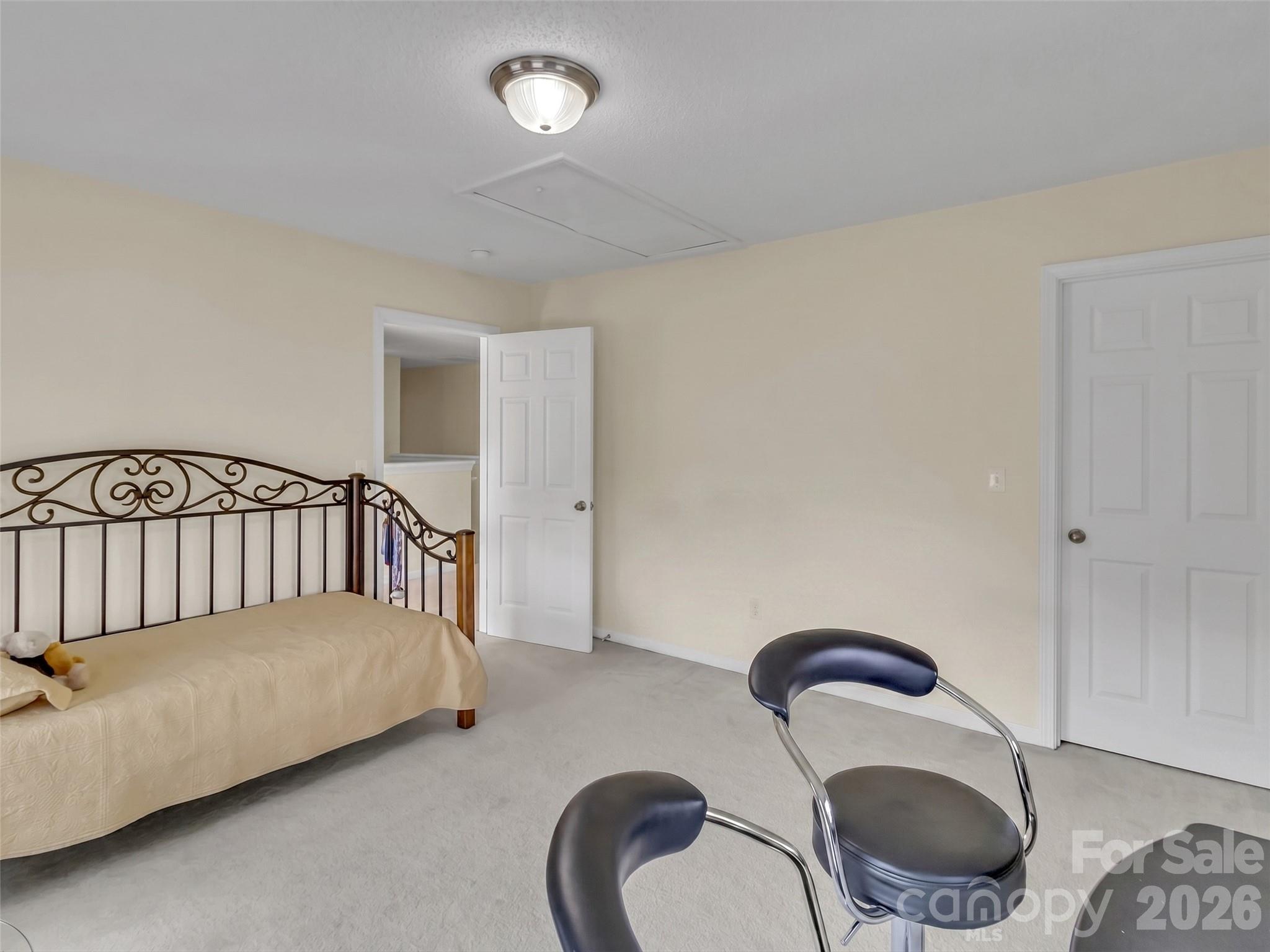 237 Midway Crossing Drive Clyde, NC 28721 - Photo 31 of 42 a bedroom with a bed and lamp