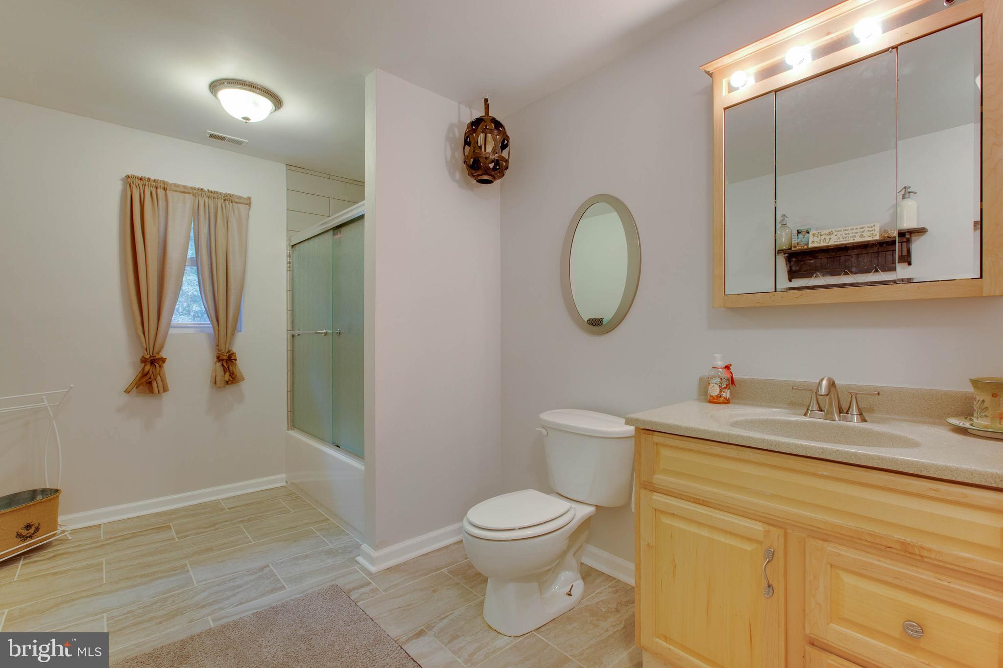 3252 Solomons Island Road Huntingtown, MD 20639 - Photo 13 of 42 Spacious main bath with storage and tiled shower