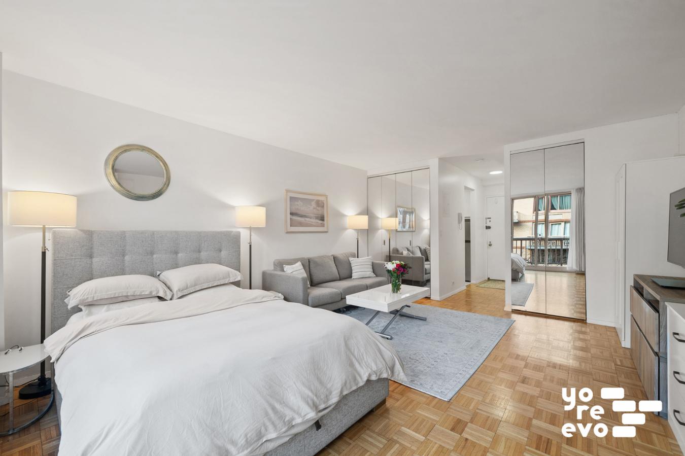 393 West 49th Street, Unit 4DD Manhattan, NY 10019 - Photo 5 of 9 a bedroom with bed and a large window