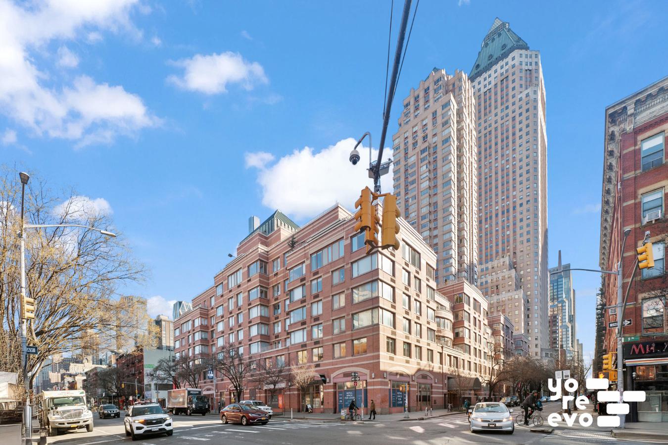 393 West 49th Street, Unit 4DD Manhattan, NY 10019 - Photo 8 of 9 a view of a buildings and cars park