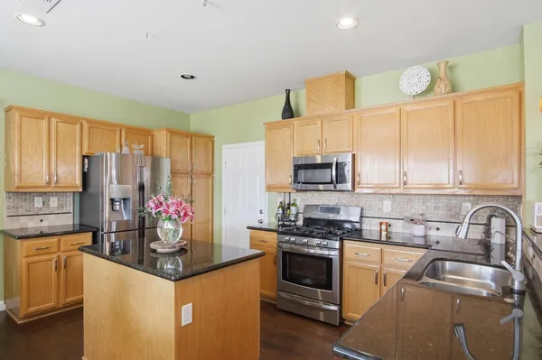 a kitchen with stainless steel appliances a sink stove and refrigerator