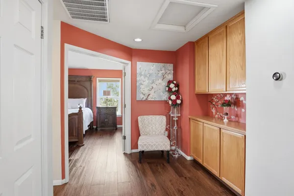 a hallway with a large window and wooden floor