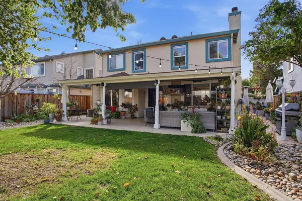 a view of a house with a yard balcony and sitting area
