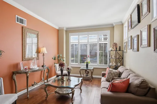 a living room with furniture and floor to ceiling windows