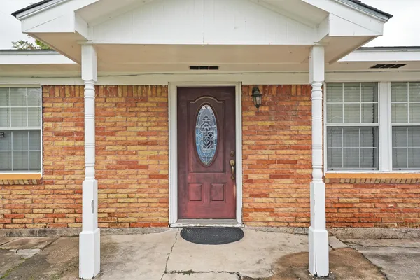 a front view of a brick house with a large window