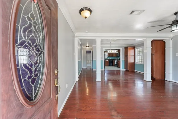 a hallway with wooden floor and a shower