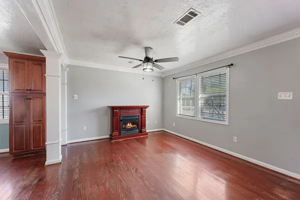 wooden floor in an empty room with a window