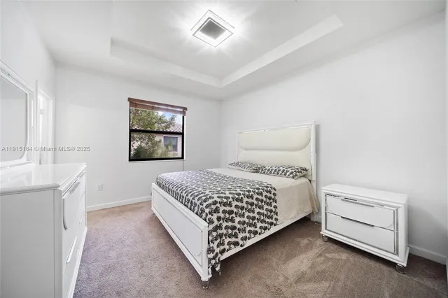 a bedroom with a bed and a night stand