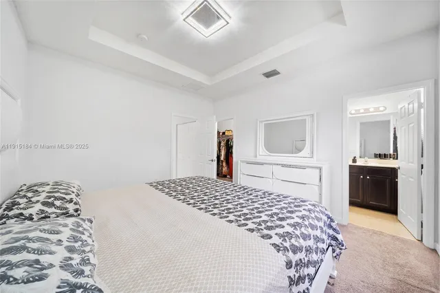 a bedroom with a large bed and a dresser