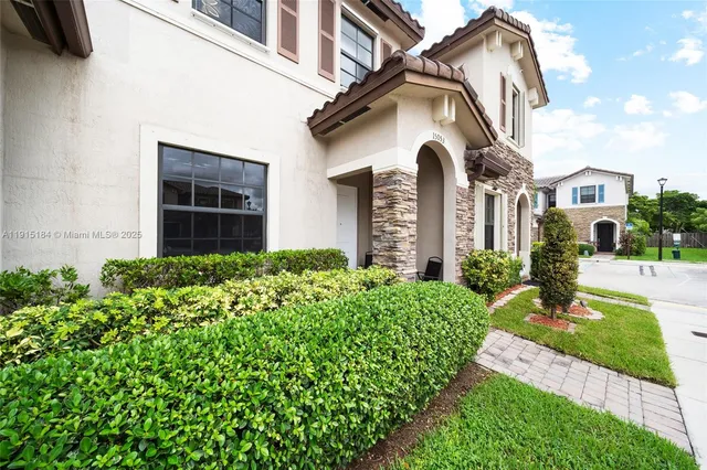 a front view of a house with garden