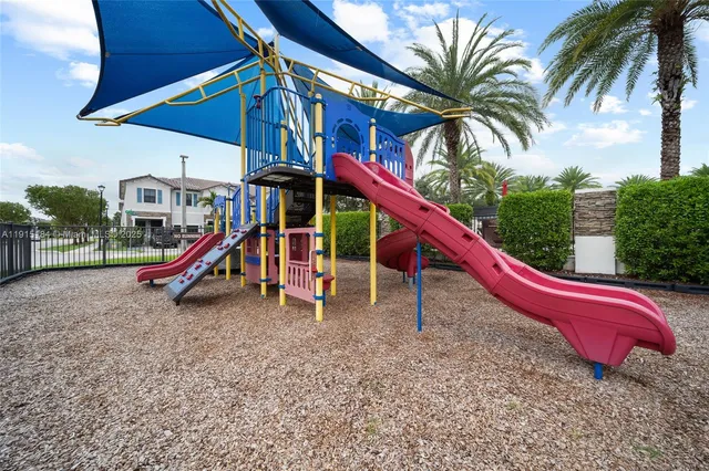 a front view of a house with swimming pool having outdoor seating